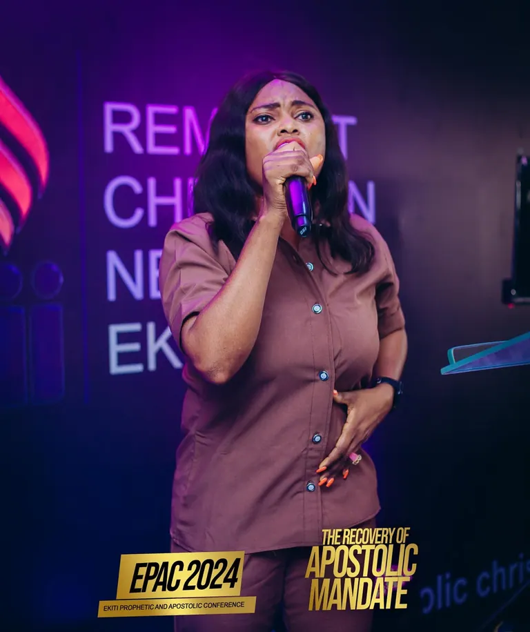 A woman ministering at the lectern during EPAC 2024