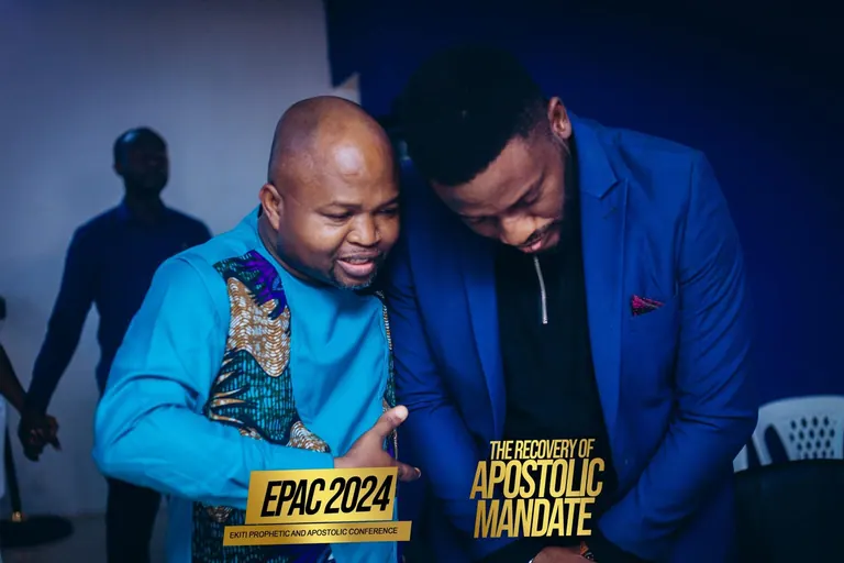 Two men praying together at EPAC 2024